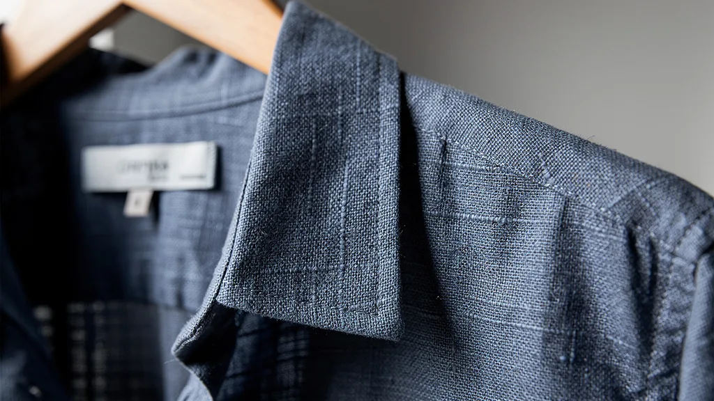 Detailed view of the textured weave of a blue premium linen shirt.